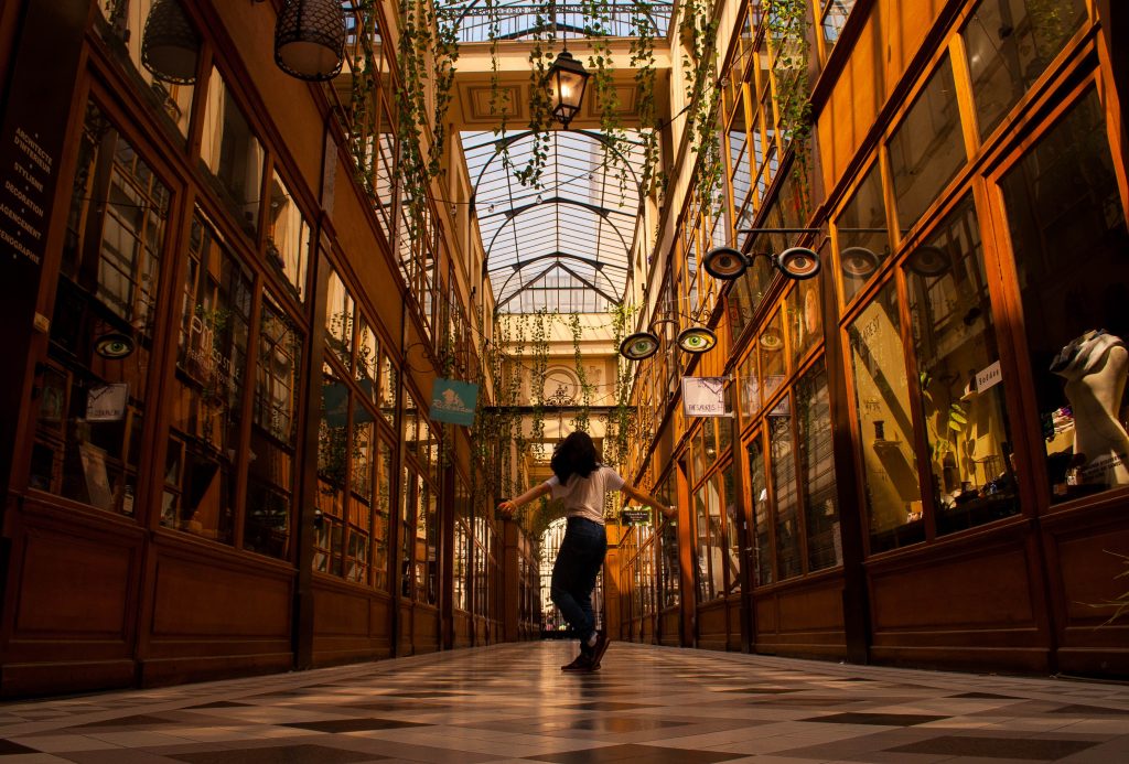 A women walking in the Passage du Grand Cerf shopping gallery.